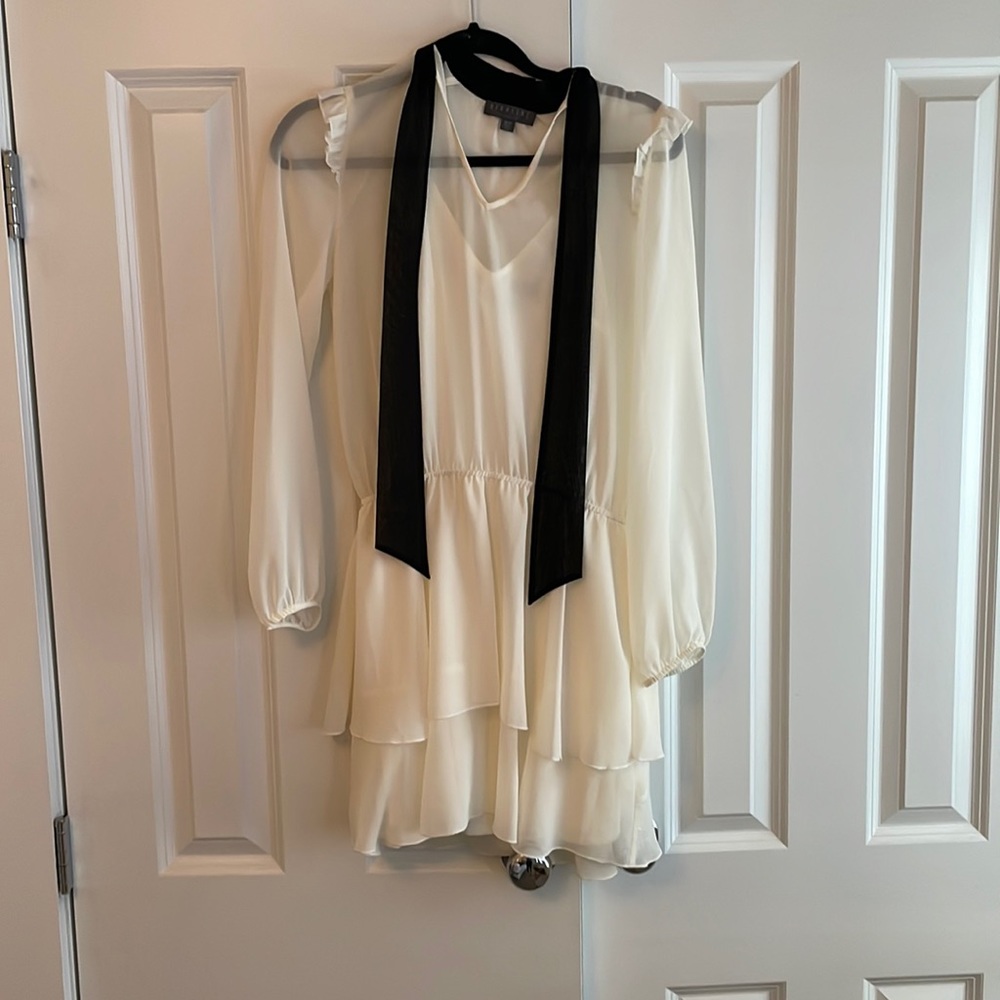 White Short Dress with beautiful detail of black bow around the neck.
